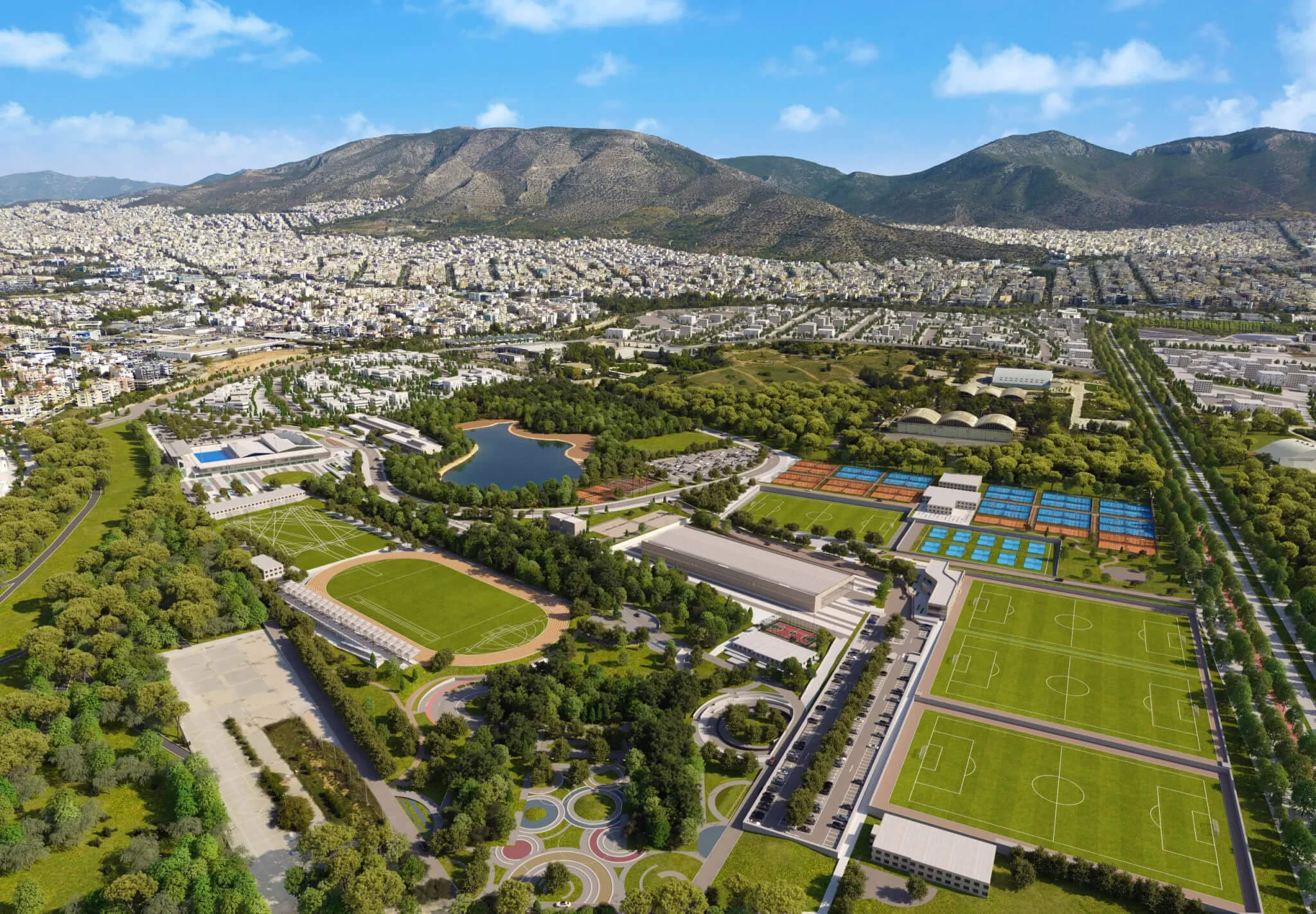 The Ellinikon Sports Park Football fields and a running track with grass and surrounding facilities. On the left, swimming pools and a lake.