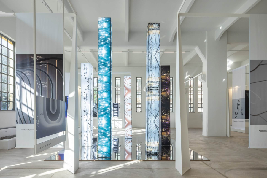 "Landmarks of Connection” Exhibition Illuminated columns wrapped with photographs in the exhibition venue.